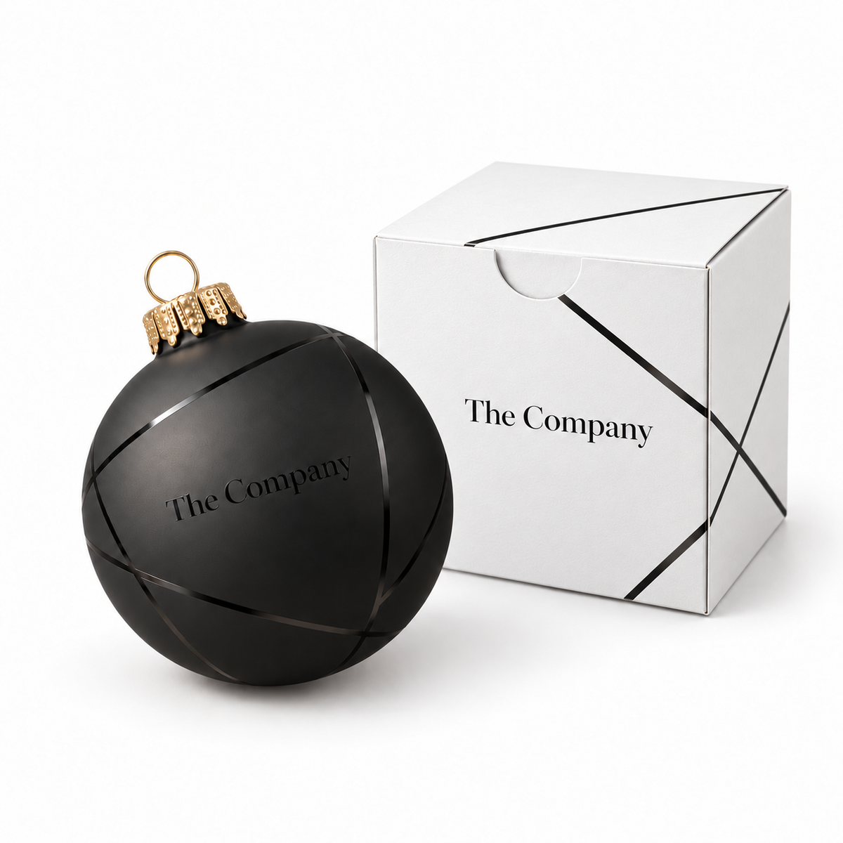 Weihnachtskugel und weisse Schachtel mit schwarzem Ornament